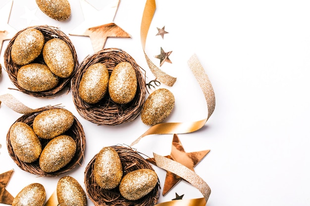 Golden glitter eggs in a nest Easter background Finance concept