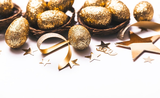 Golden glitter eggs in a nest Easter background Finance concept