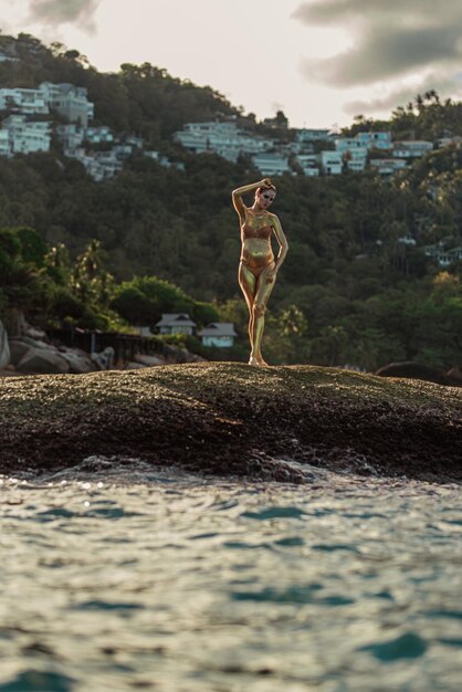 Golden glitter girl in the ocean