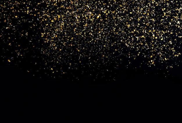 Golden glitter texture on black abstract