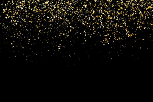 Golden glitter texture on black abstract