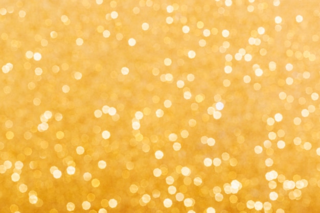 Golden glowing sparkles blurred background