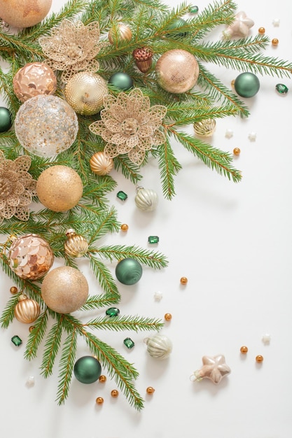 Golden and green christmas decorations on white background