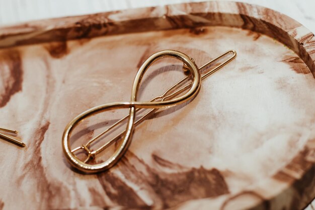 Golden hairpins on the background of a marble decorated plaster stand social media content