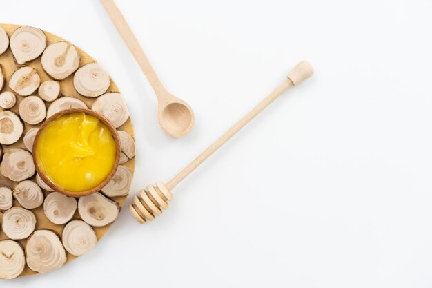 Golden honey in the wooden bowl with dipper.