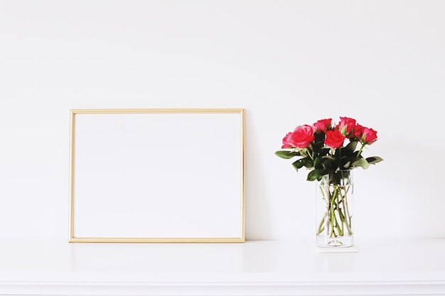 Golden horizontal frame and bouquet of rose flowers