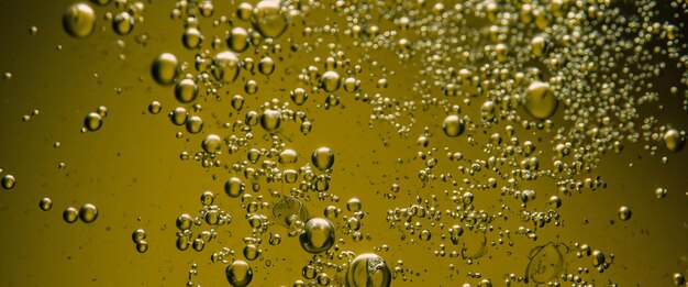 Photo golden hyaluron oil bubbles collagen serum or yellow oil bubbles drop texture background liquid transparent droplets skincare essential product with dribs honey syrup bubble oil droplets close up