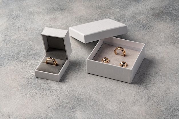 Golden jewellery in box on gray background