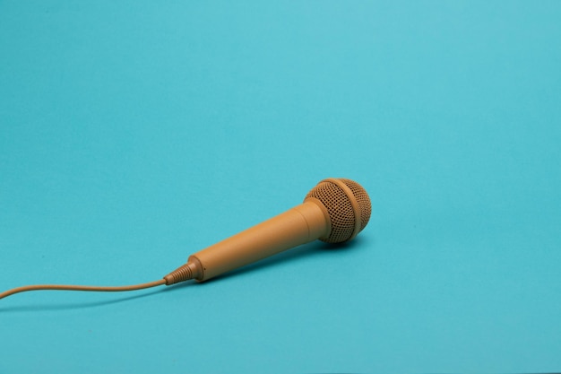 Golden karaoke microphone on a blue background