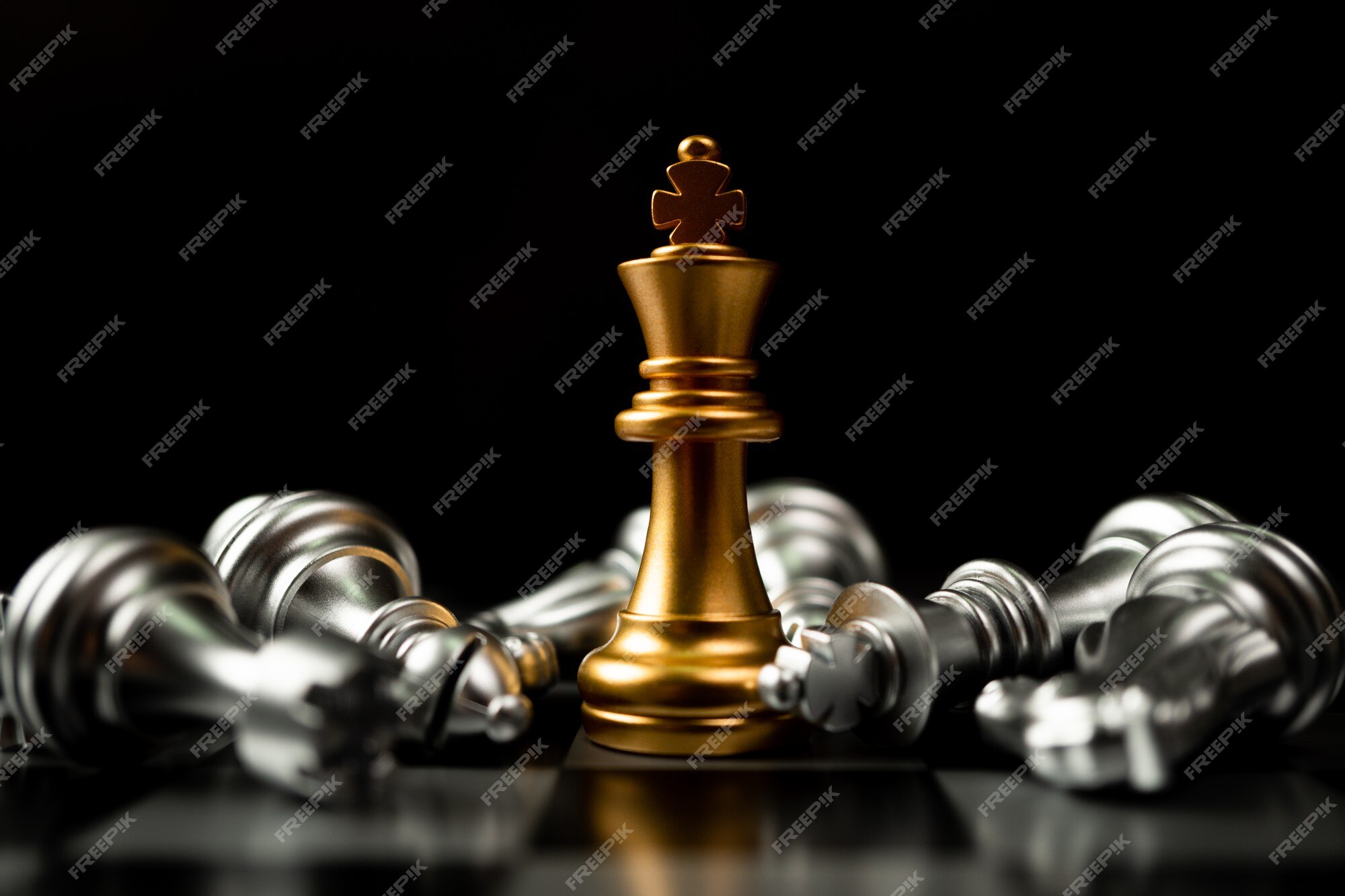 Premium Photo  Golden king chess standing with chess pieces lying