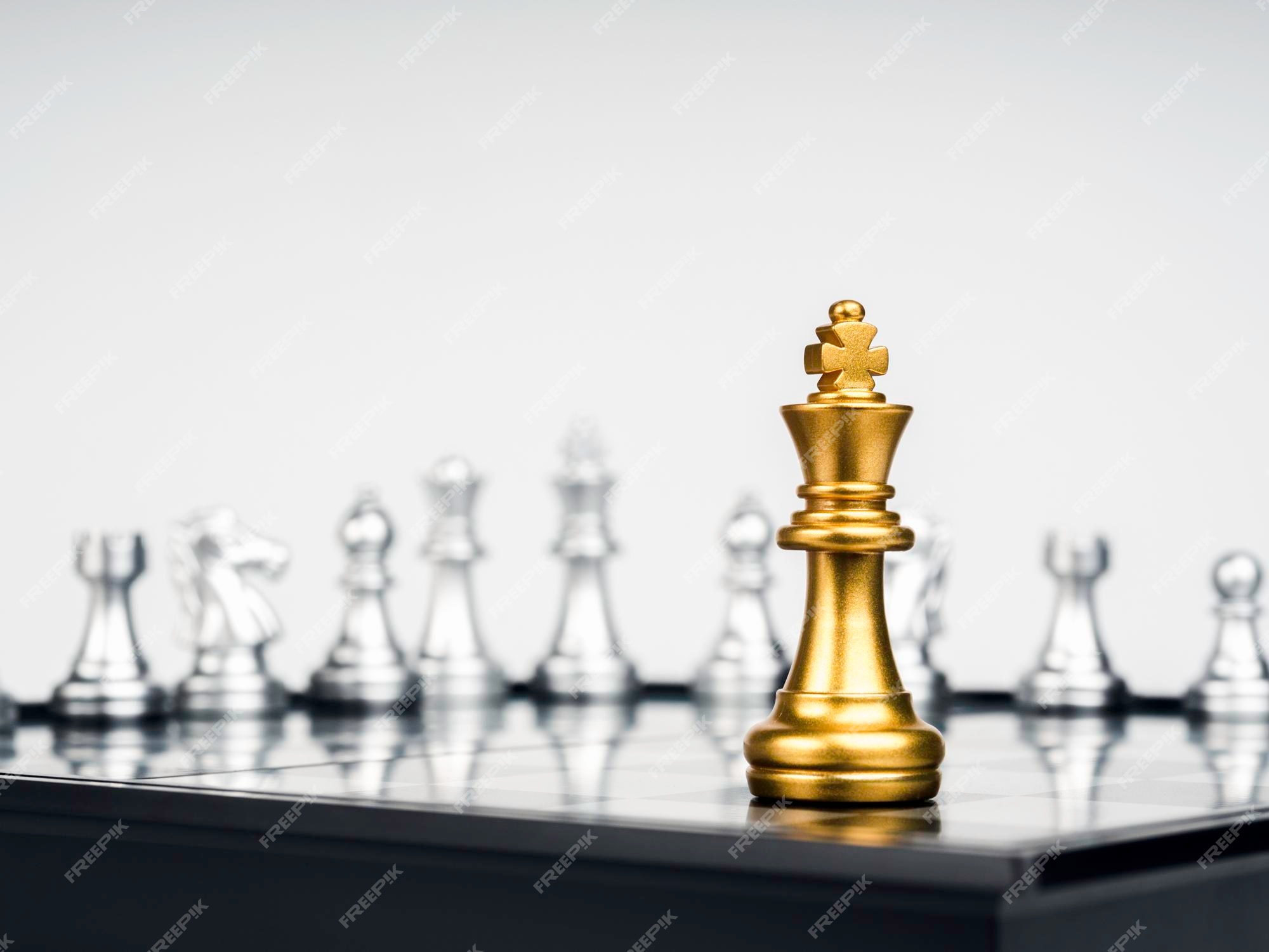 Premium Photo, Golden king chess is last standing in the chess board