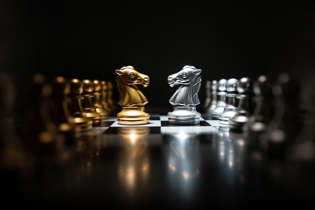 Golden knight chess encounters with silver knight chess on a board Business competition leadership and success concept