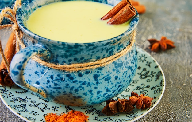 Golden latte turmeric healthy drink in a blue cup