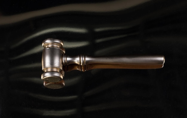 golden law hammer isolated on black background