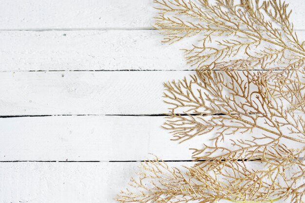 Golden leaves on white wood