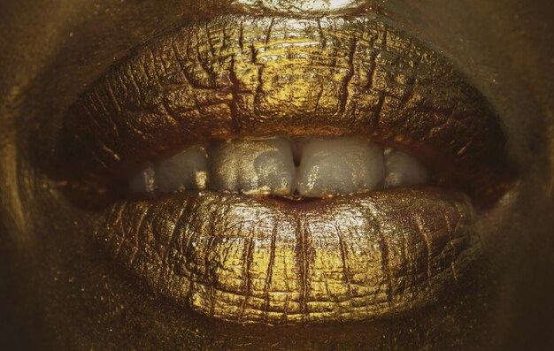 Golden lips macro close up gold lips gold paint from the mouth
golden lips on woman mouth with makeu