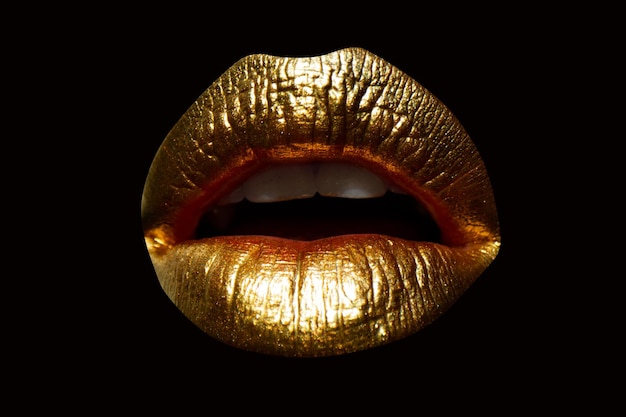 Golden lips with gold lipstick on isolated background Sensual girl or woman mouth with gold