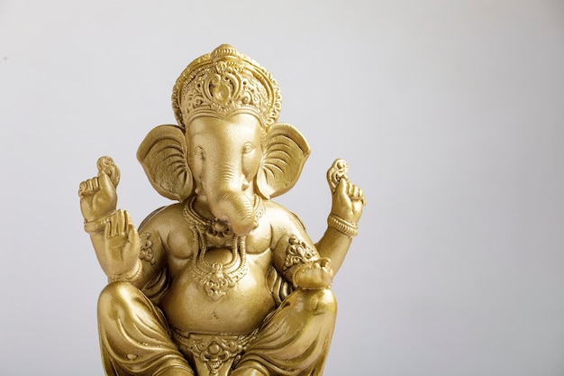 Golden lord ganesha sclupture over dark background. celebrate lord ganesha festival.