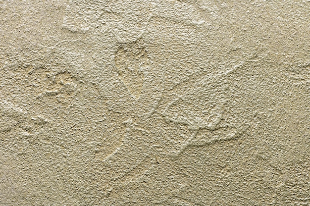 Golden messy wall stucco texture. Closeup decorative plaster paint for background.