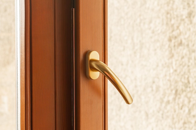 Golden metal window or door handle closeup