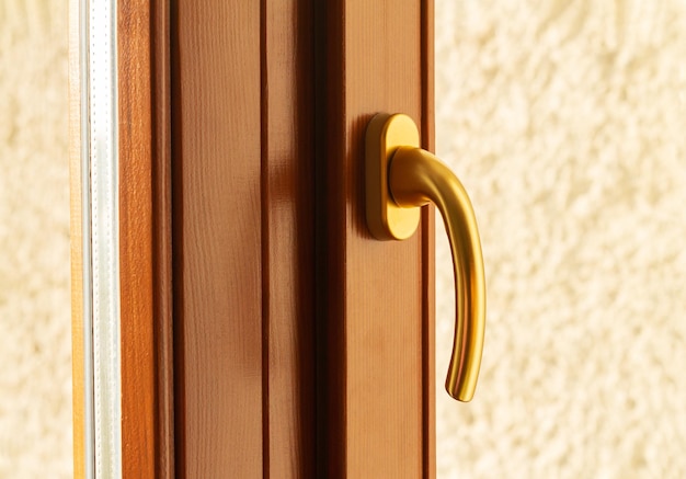 Photo golden metal window or door handle closeup