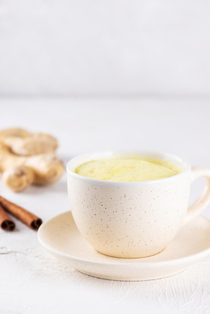 Golden milk with almond milk ginger turmeric and cinnamon in a mug sugar and lactose free