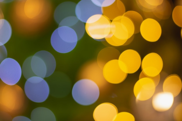 Golden and multicolored bokeh circle background for christmas and happy new year with space to display messages