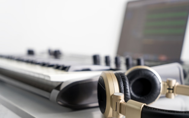 Golden Music Studio headphone with Computer music producing equipment.