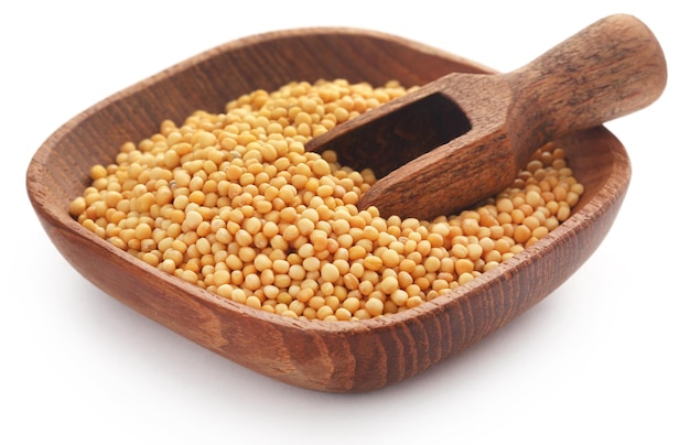 Golden Mustard seeds in a wooden bowl