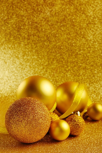 Golden New Year tree toys with glitter background.