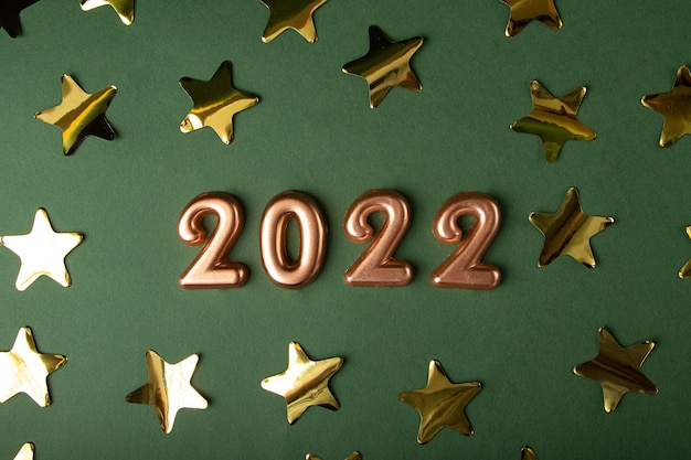 Golden numbers 2022 on the green background.New year card.