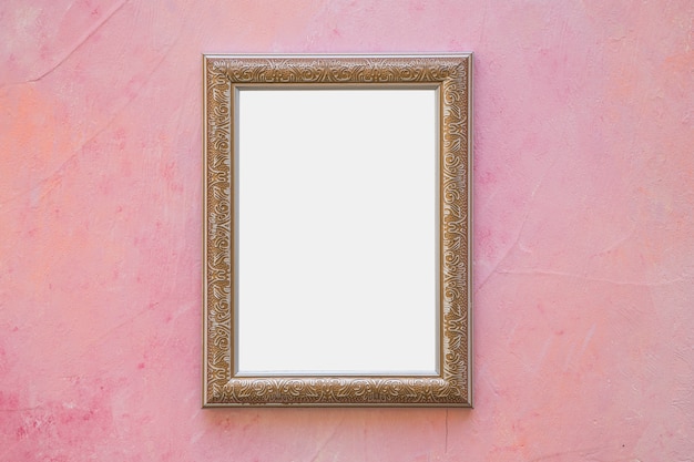 Golden ornate white frame on pink wall