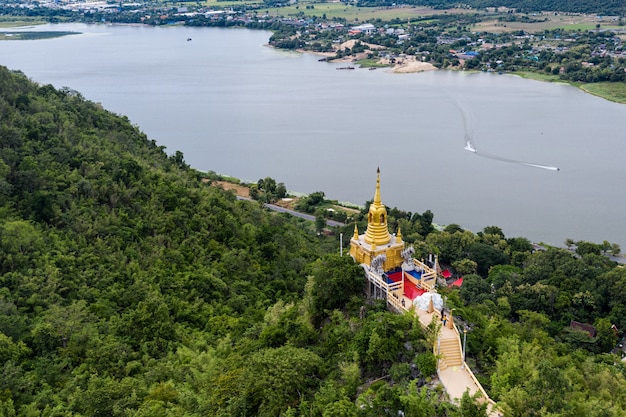 Golden pagoda on hill in tropical rainforest on Wat Ban Tham