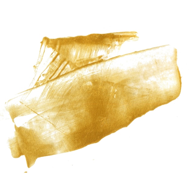 Photo golden paint stain isolated on white background. shiny gold texture made with palette knife.