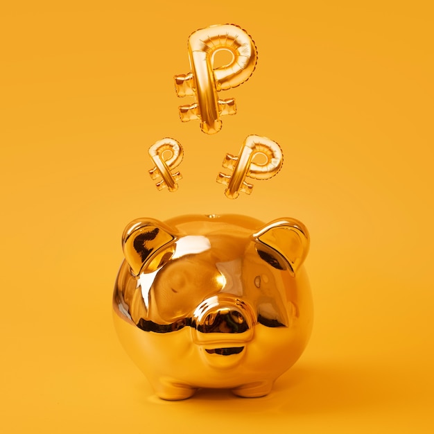 Golden piggy bank on yellow background with golden ruble sign balloons, russian currency symbol made of foil balloon