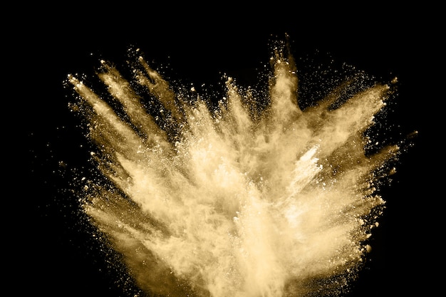 Golden powder explosion on black background.