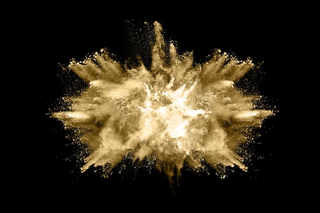 Golden powder explosion on black background 