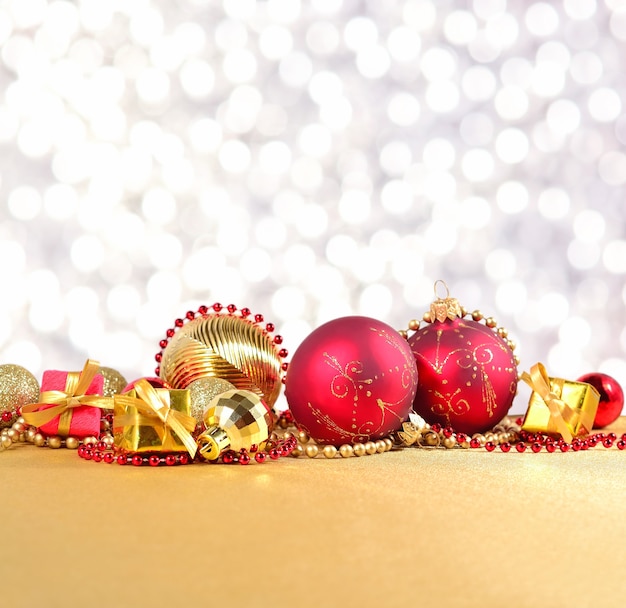 Golden and red Christmas decorations on a silvery background