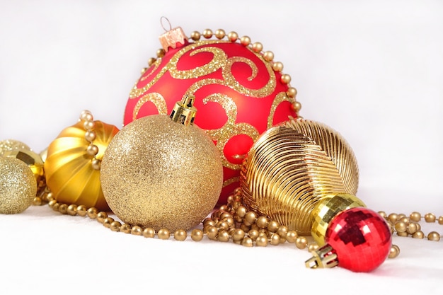 Golden and red Christmas decorations on a white