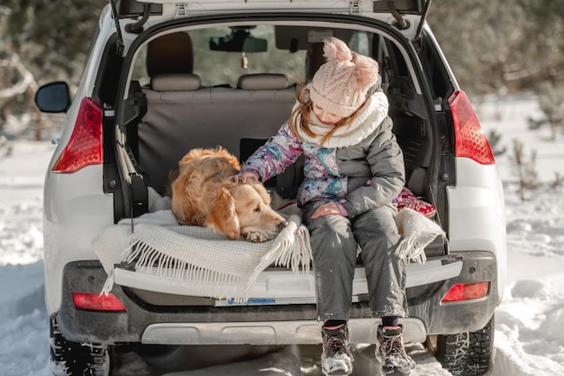 Golden retriever dog with girl in winter time