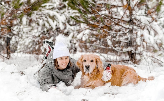 Golden retriever dog with girl in winter time