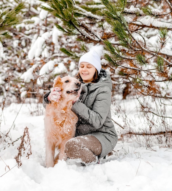 Golden retriever dog with girl in winter time