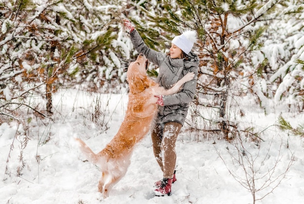 Golden retriever dog with girl in winter time