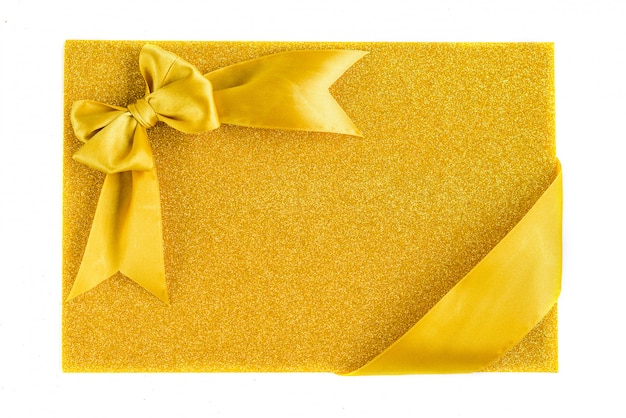 Фото Золотая лента лук на блеске золотая половина белого на диагонали фоне. праздничный фон с копией пространства.