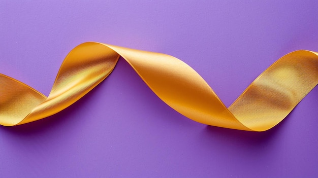 Golden ribbon isolated on purple background Closeup Copy space