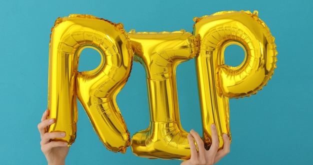 Golden RIP words made of inflatable balloons