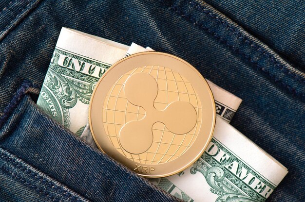 Golden ripple coin and us dollars in blue jeans pocket exchange save and withdrawal of