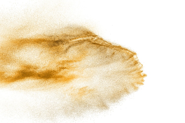 黄金の砂の爆発は、白い背景にします。