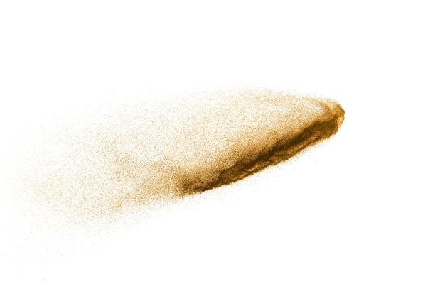 Golden sand explosion isolated on white background. Abstract sand cloud.