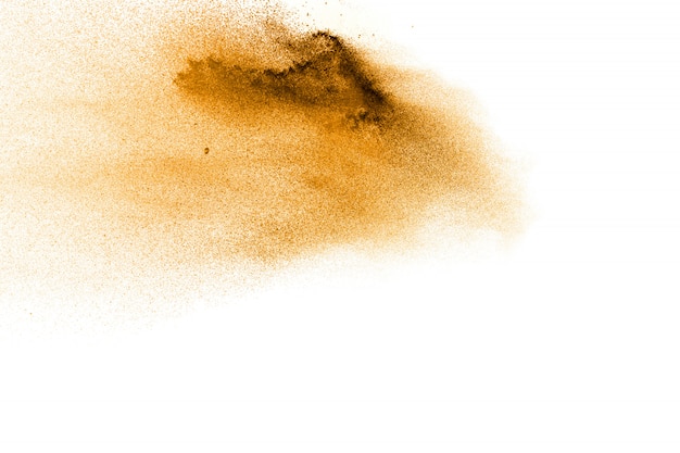 Golden sand explosion isolated on white background. abstract sand splashing.